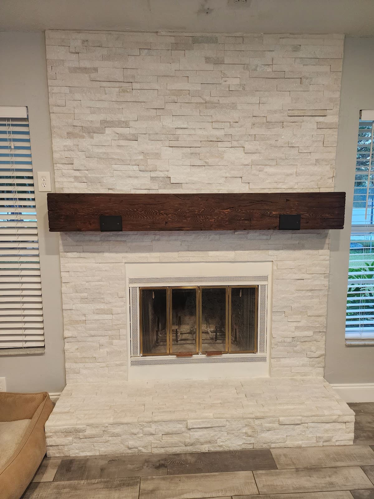 Stacked-stone fireplace and rustic wood mantel remodeled by Devon's HomePro in Spring Hill, FL